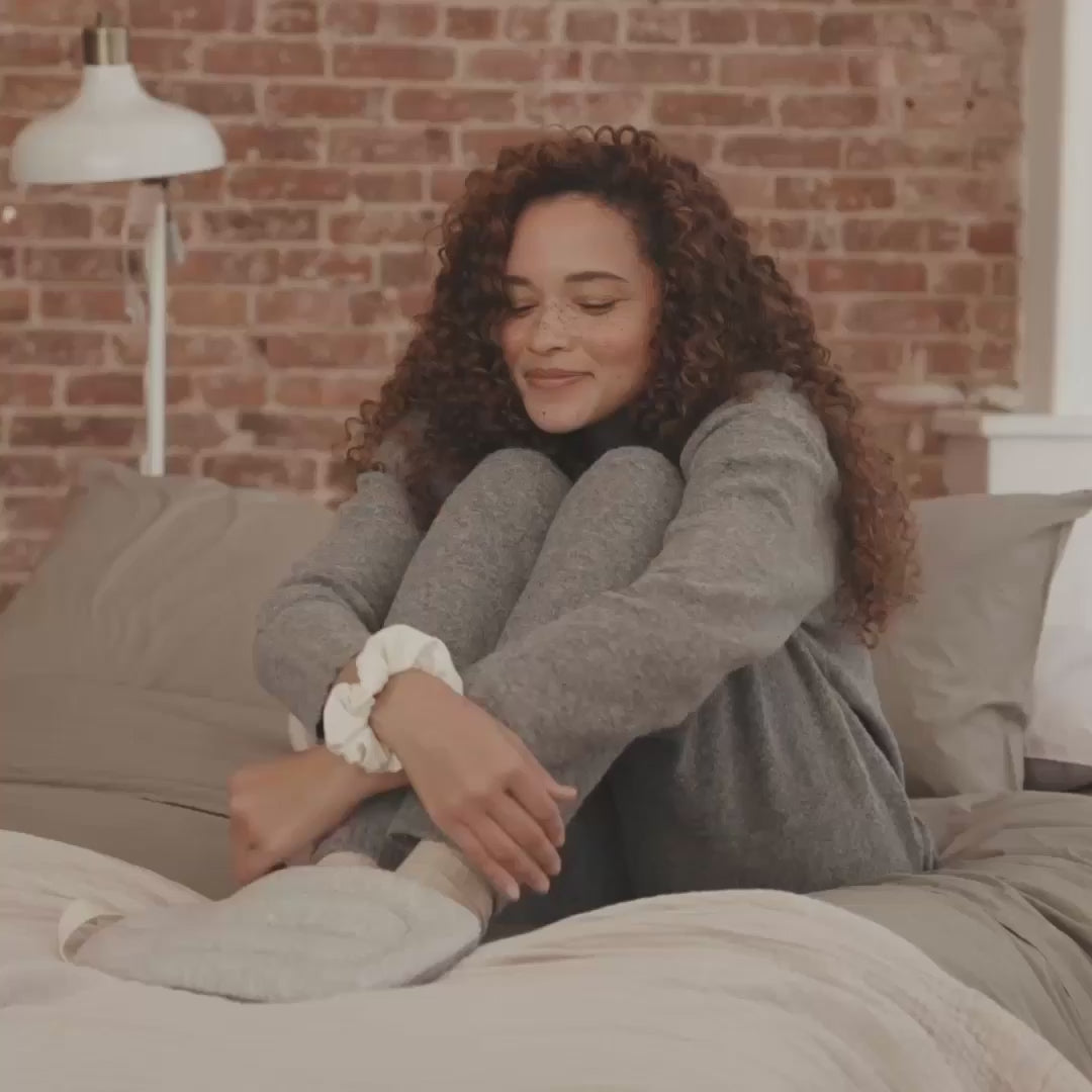 lady relaxing feet with heated bottle
