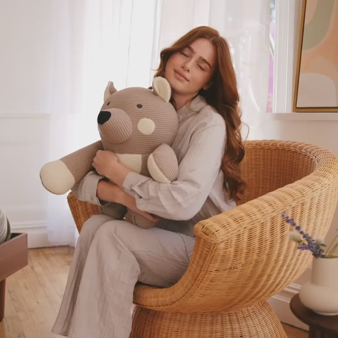 girl holding the weiighted bear plushies